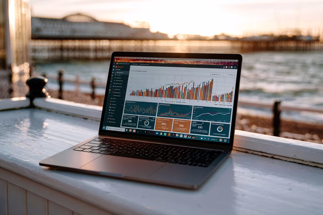 Power BI dashboard on a laptop with Brighton in the background