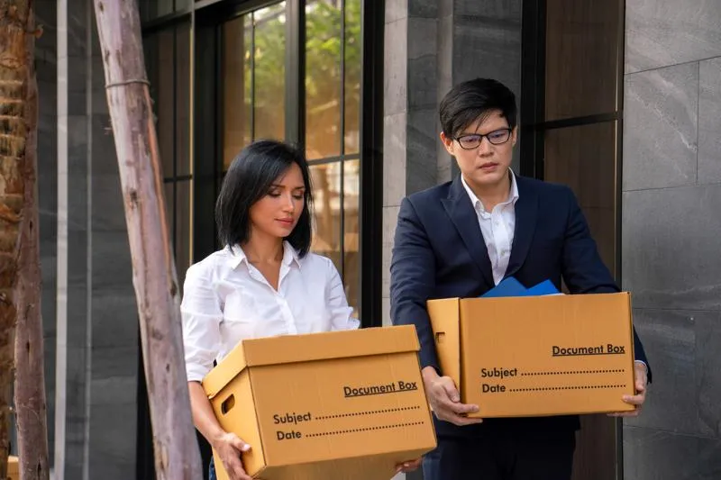 Employés en train de déplacer des cartons de documents pour le déménagement de leur bureau