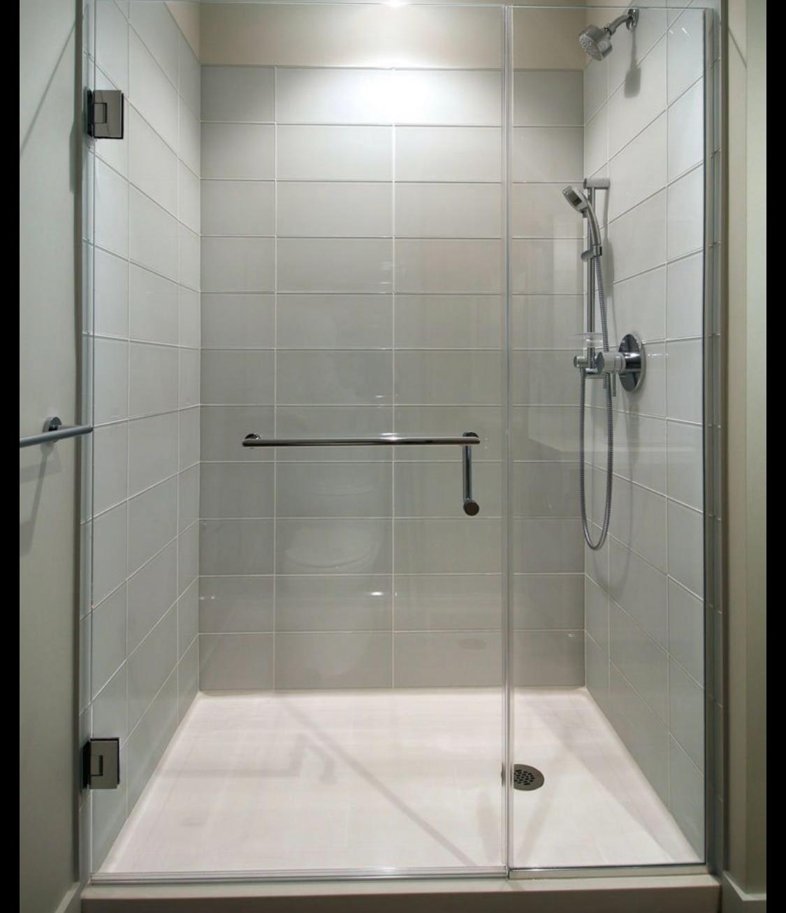 Custom glass shower enclosure with black marble tile.