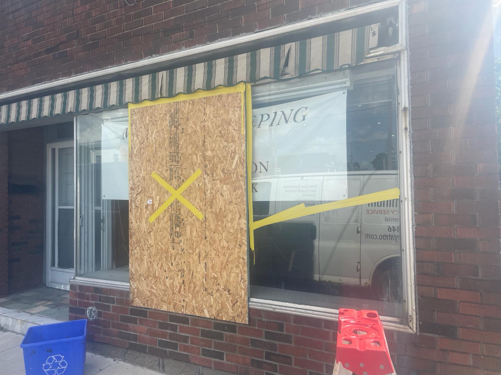 Commercial window board-up with plywood panel