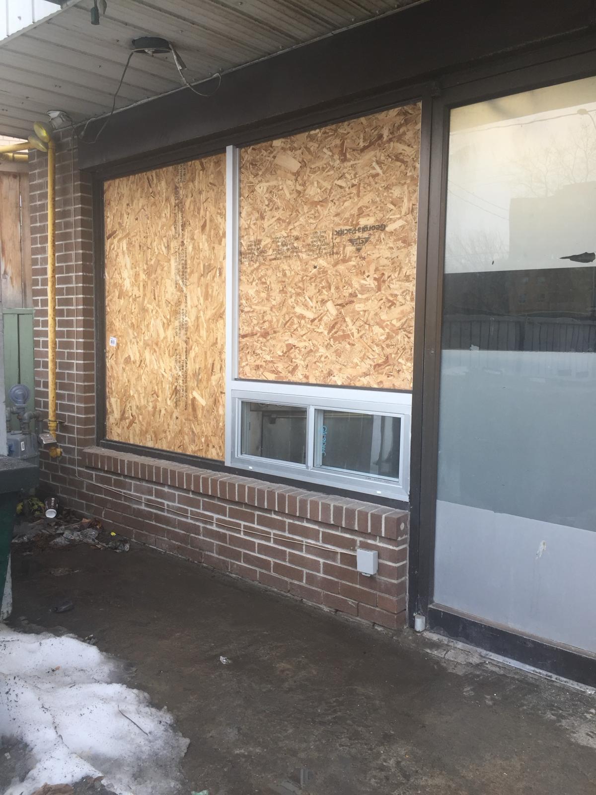 Commercial window board-up with plywood panel