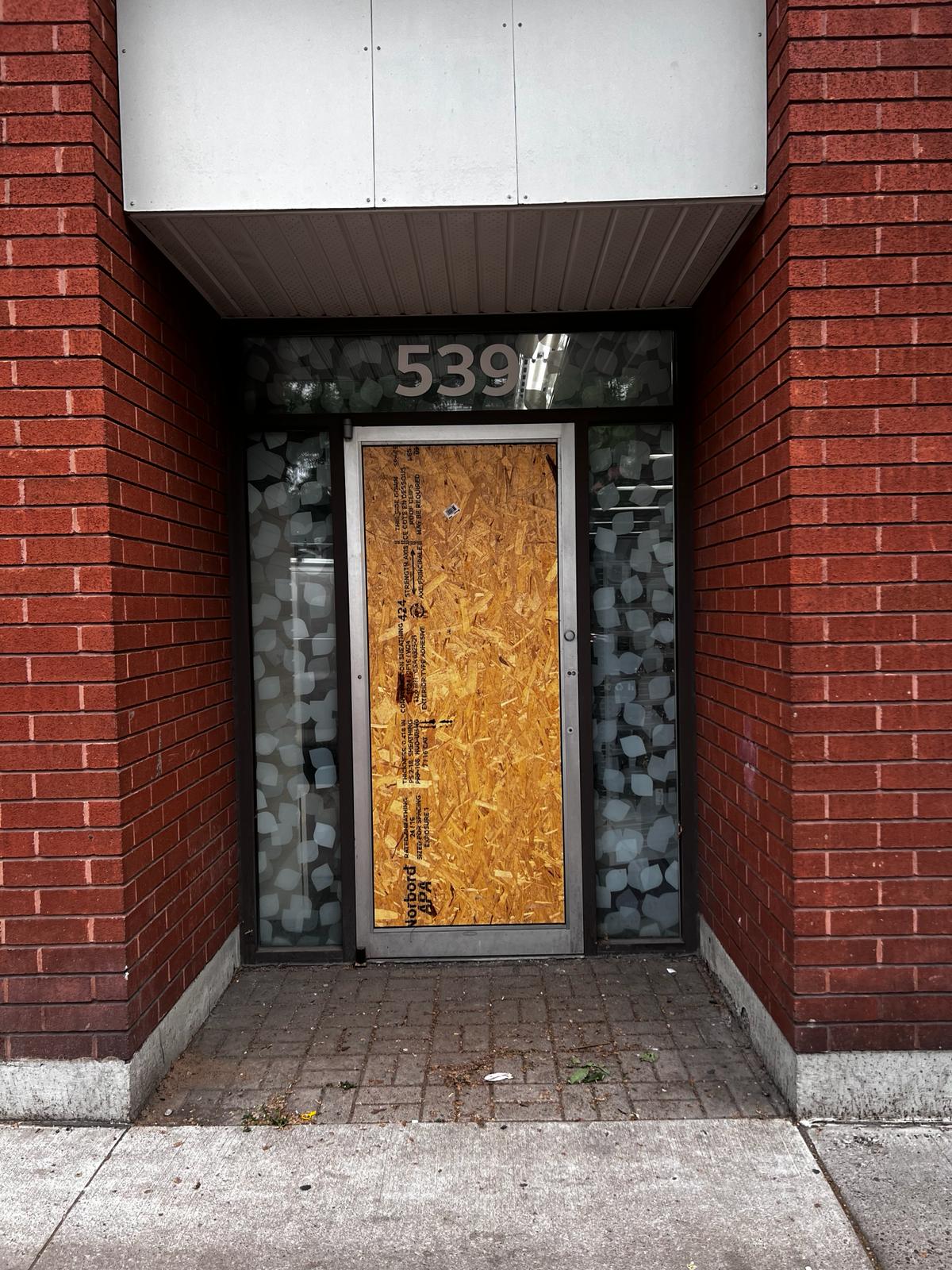 Commercial door board-up with plywood panel