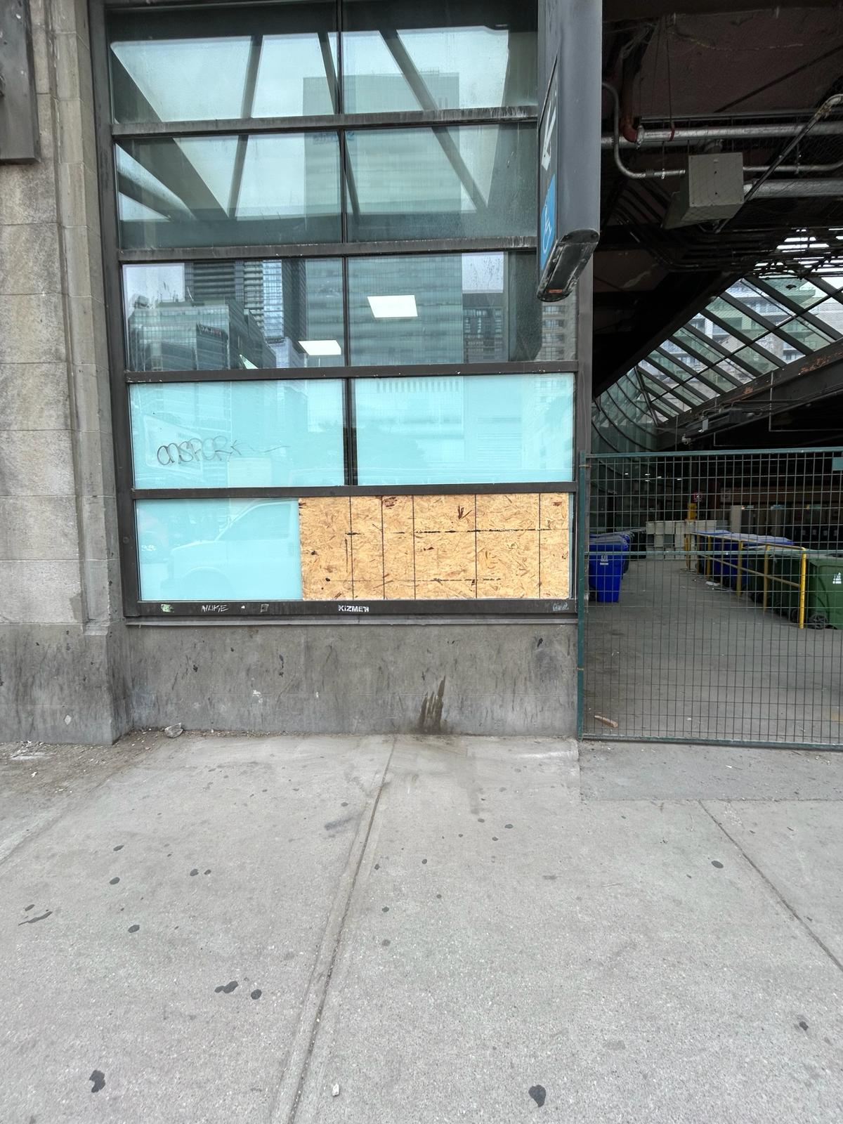 Commercial window board-up with plywood panel