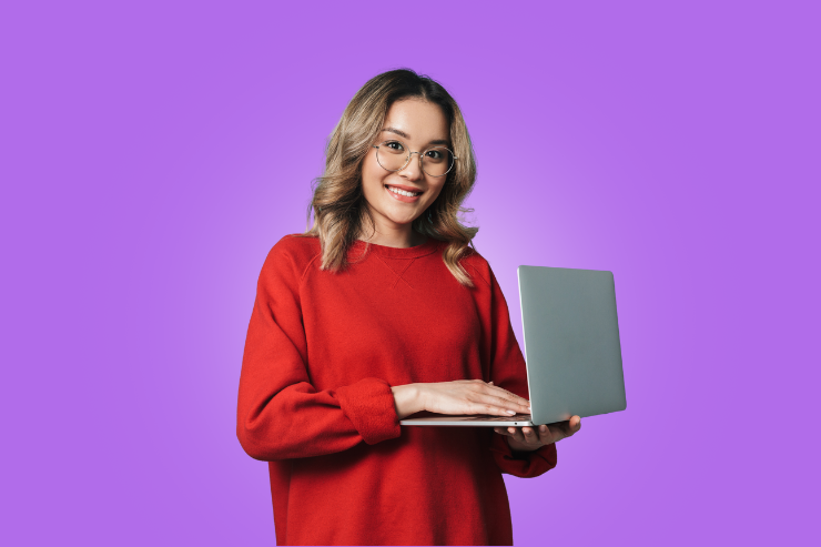 Happy student holding laptop