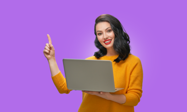 Happy student holding laptop