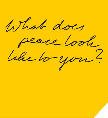 Handwritten black text on a yellow background reading: 'What does peace look like to you?'
