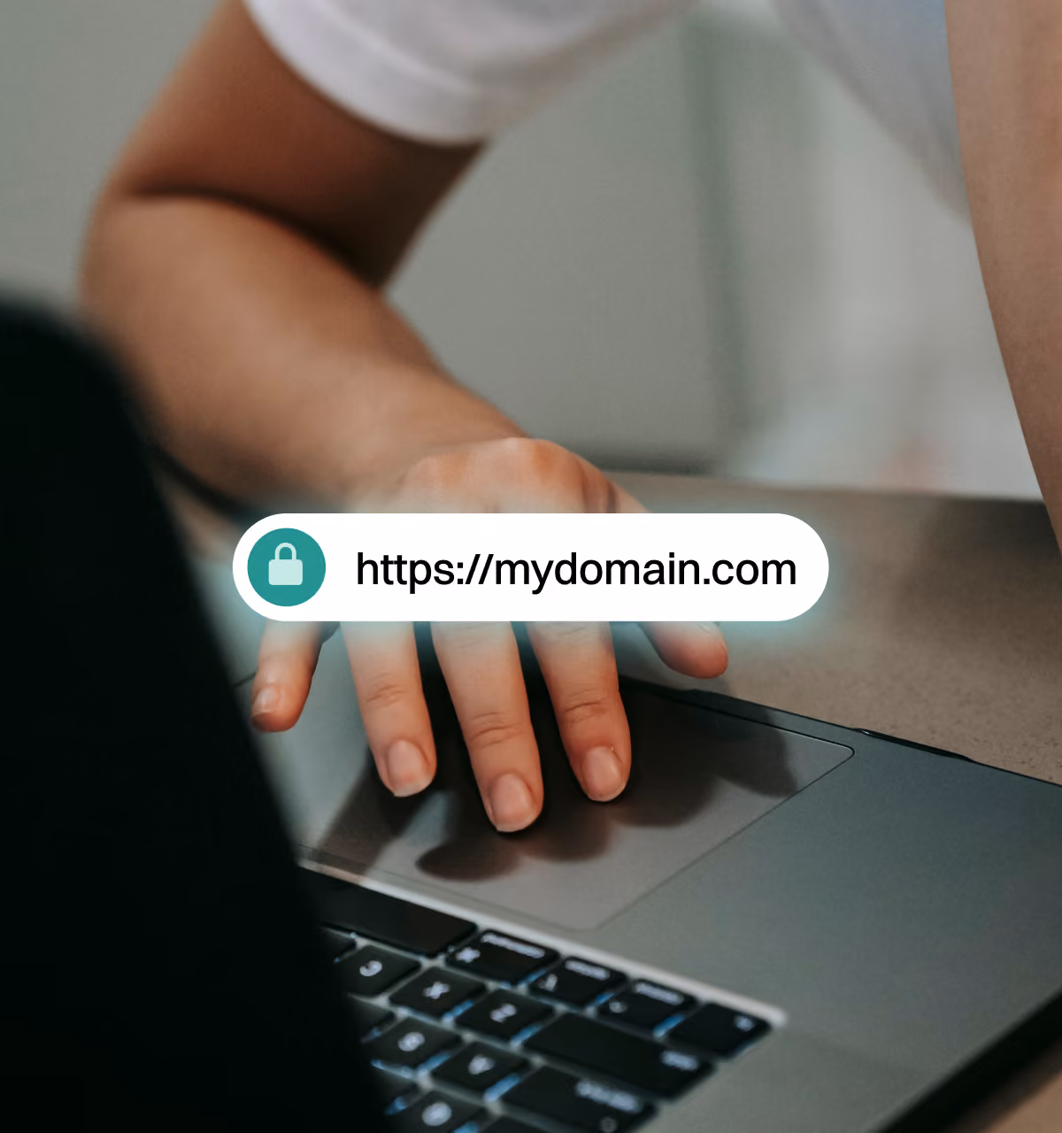 Hand on a laptop trackpad below a secure browser bar showing a custom checkout domain, https://mydomain.com