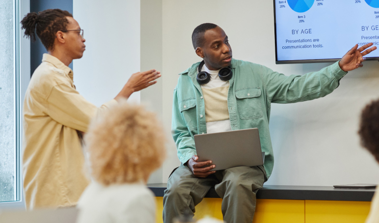Team member presenting a new product launch plan to colleagues in a meeting
