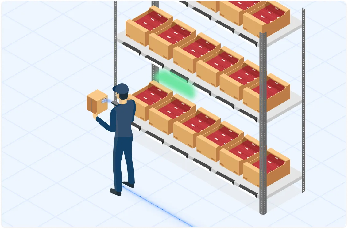 Warehouse worker scanning a box in front of shelves filled with boxes.