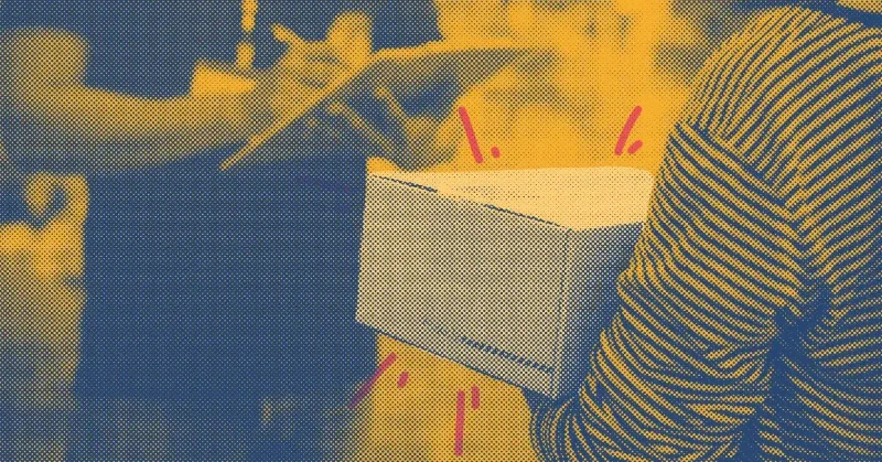 Person in striped shirt holding a cardboard box with blurred background.