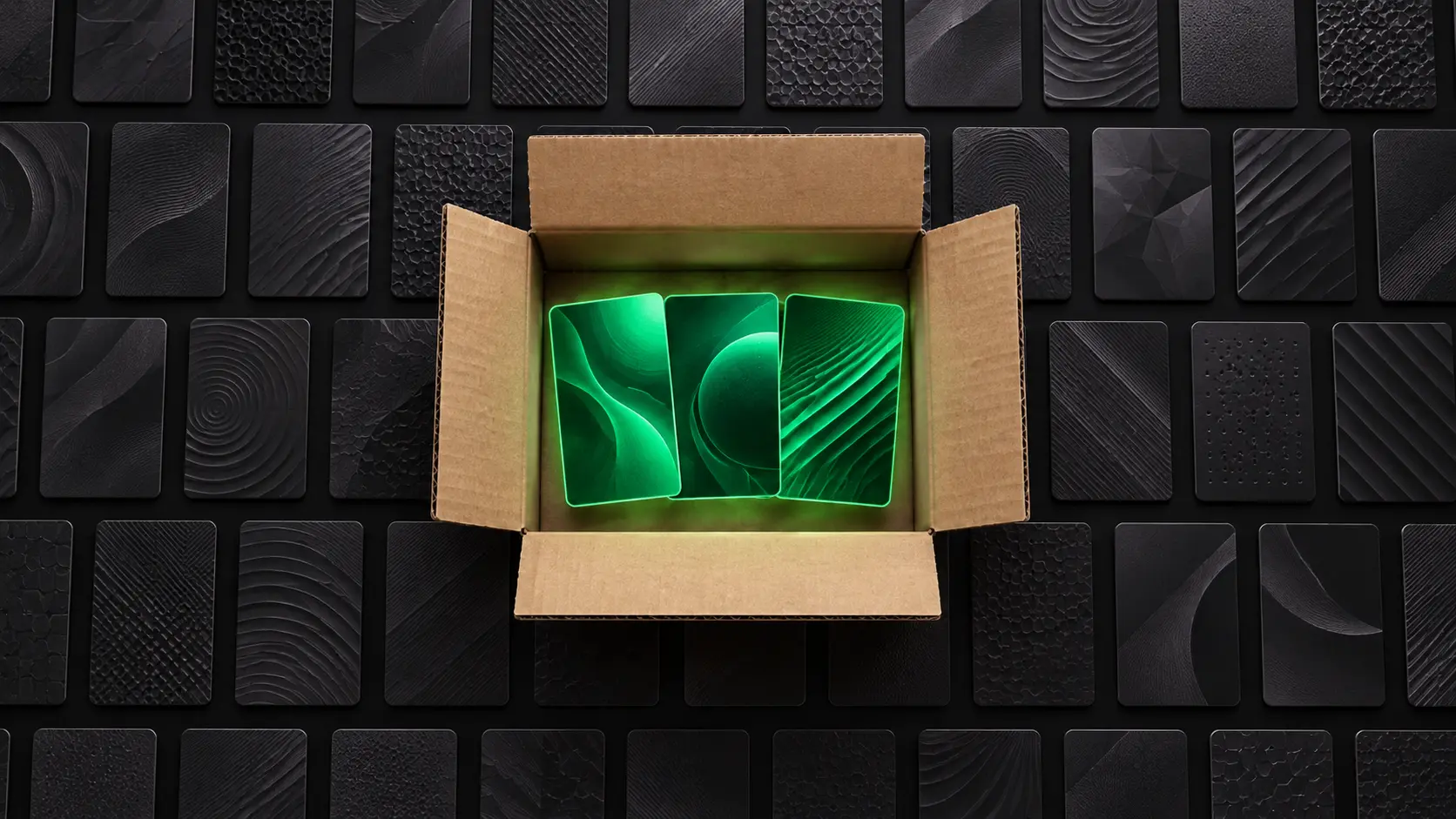 Open cardboard box with three glowing green cards inside, illustrating the ShipHero pack to light card walls concept