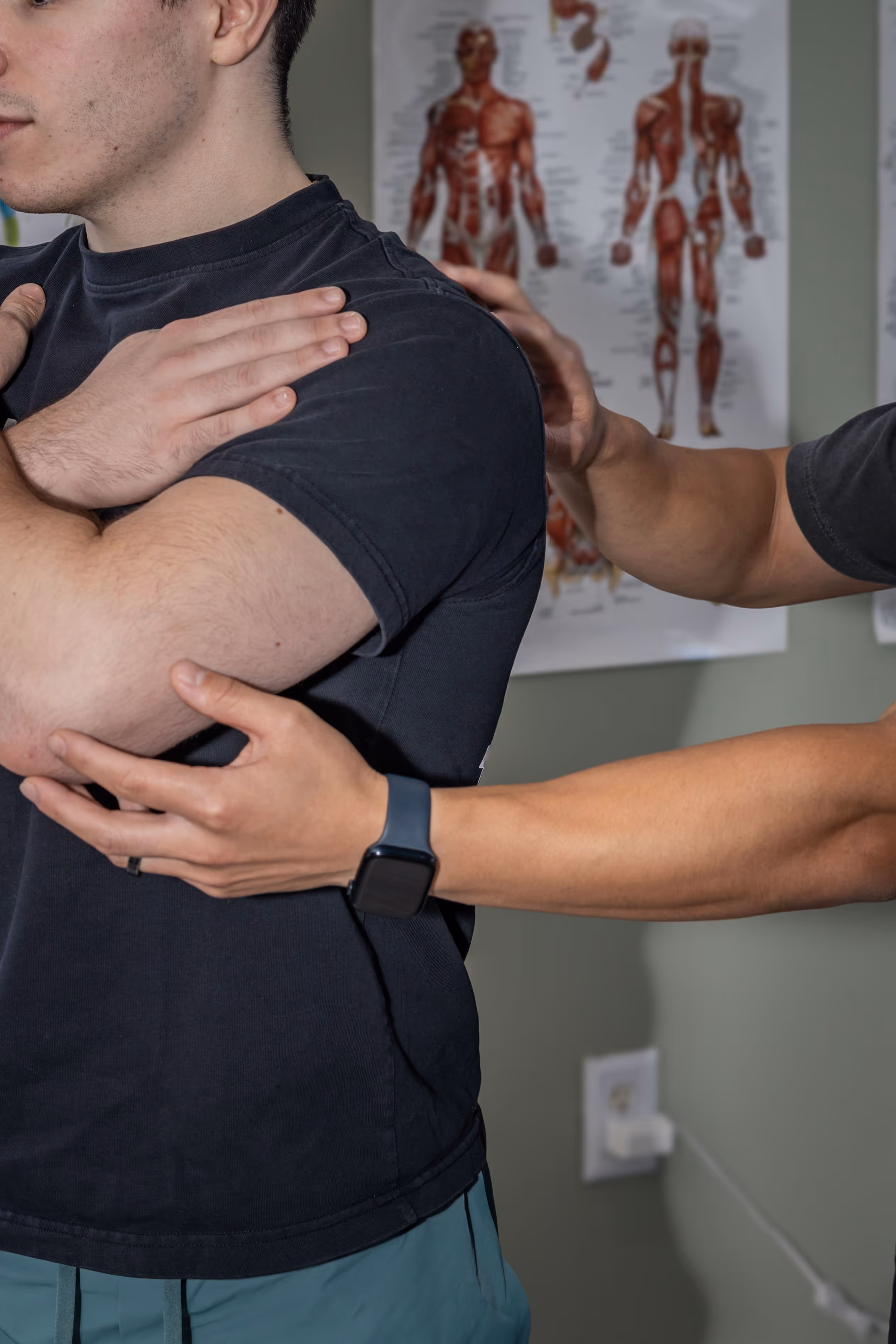 Elevate Physical therapist assisting a man with a shoulder stretch exercise indoors. physical therapy massapequa ny