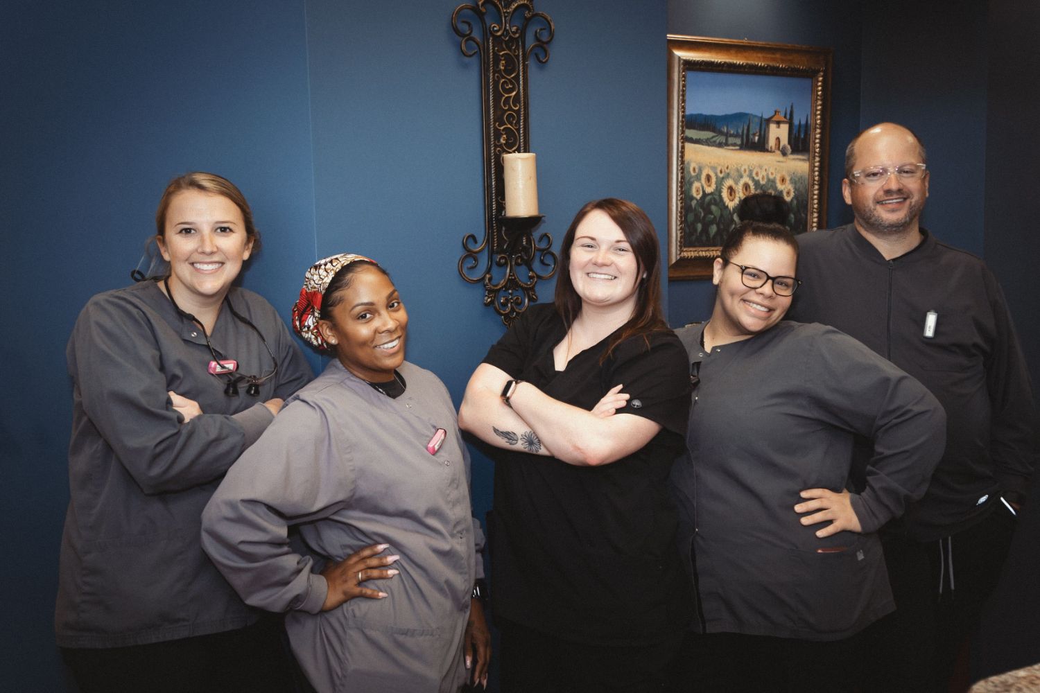 Staff members standing and smilng
