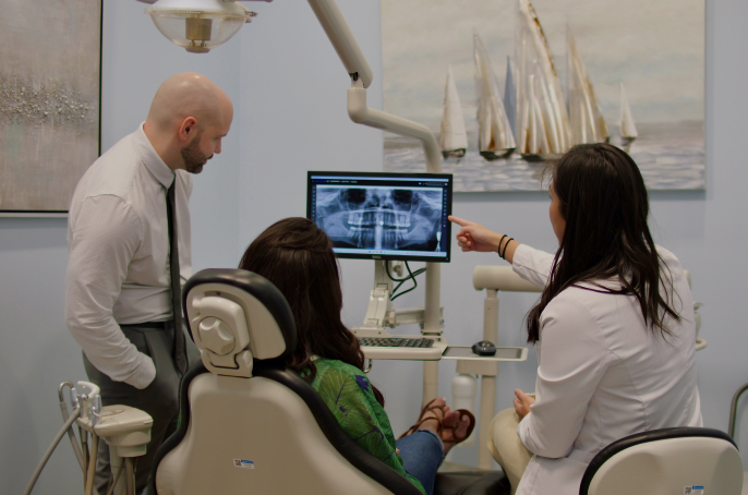 Riccobene dentists reviewing digital X-rays with a patient
