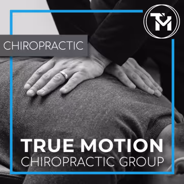 Hand of a chiropractor applying pressure on a patient's back with text True Motion Chiropractic Group.