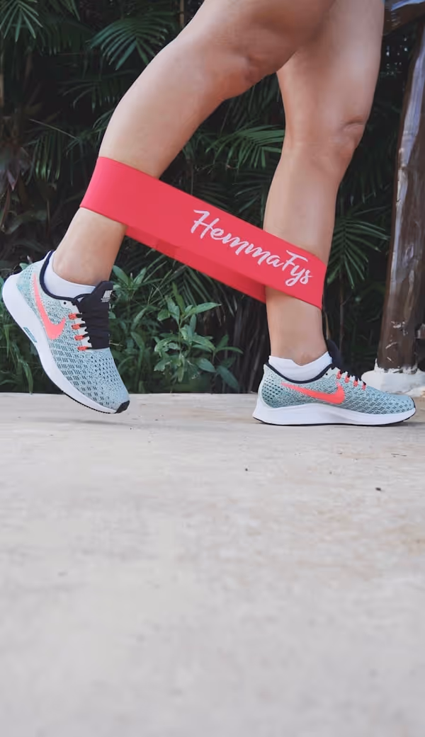 Fitness girl working out outdoors with loop band