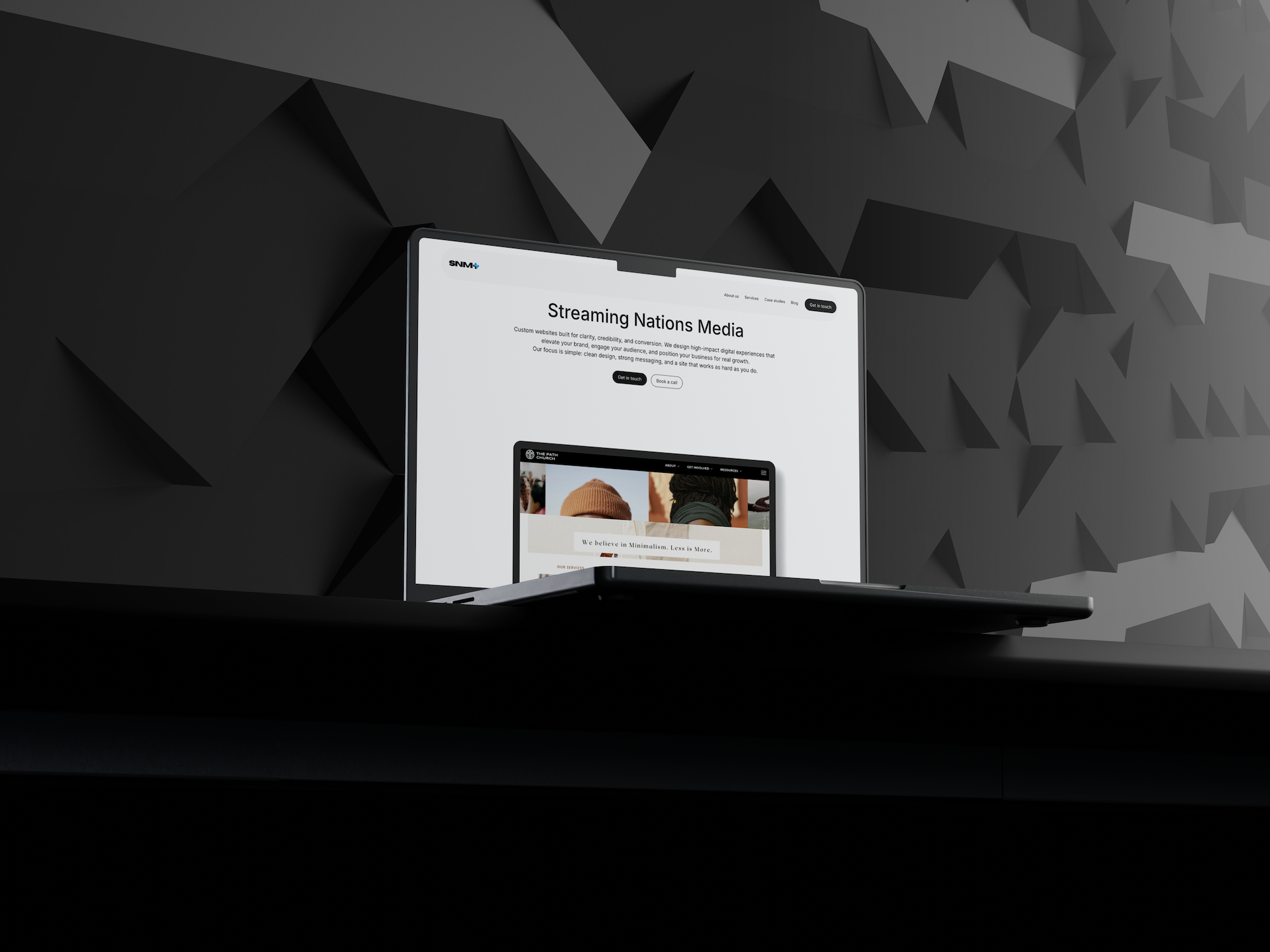 Open laptop displaying Streaming Nations Media website on a black geometric patterned background.