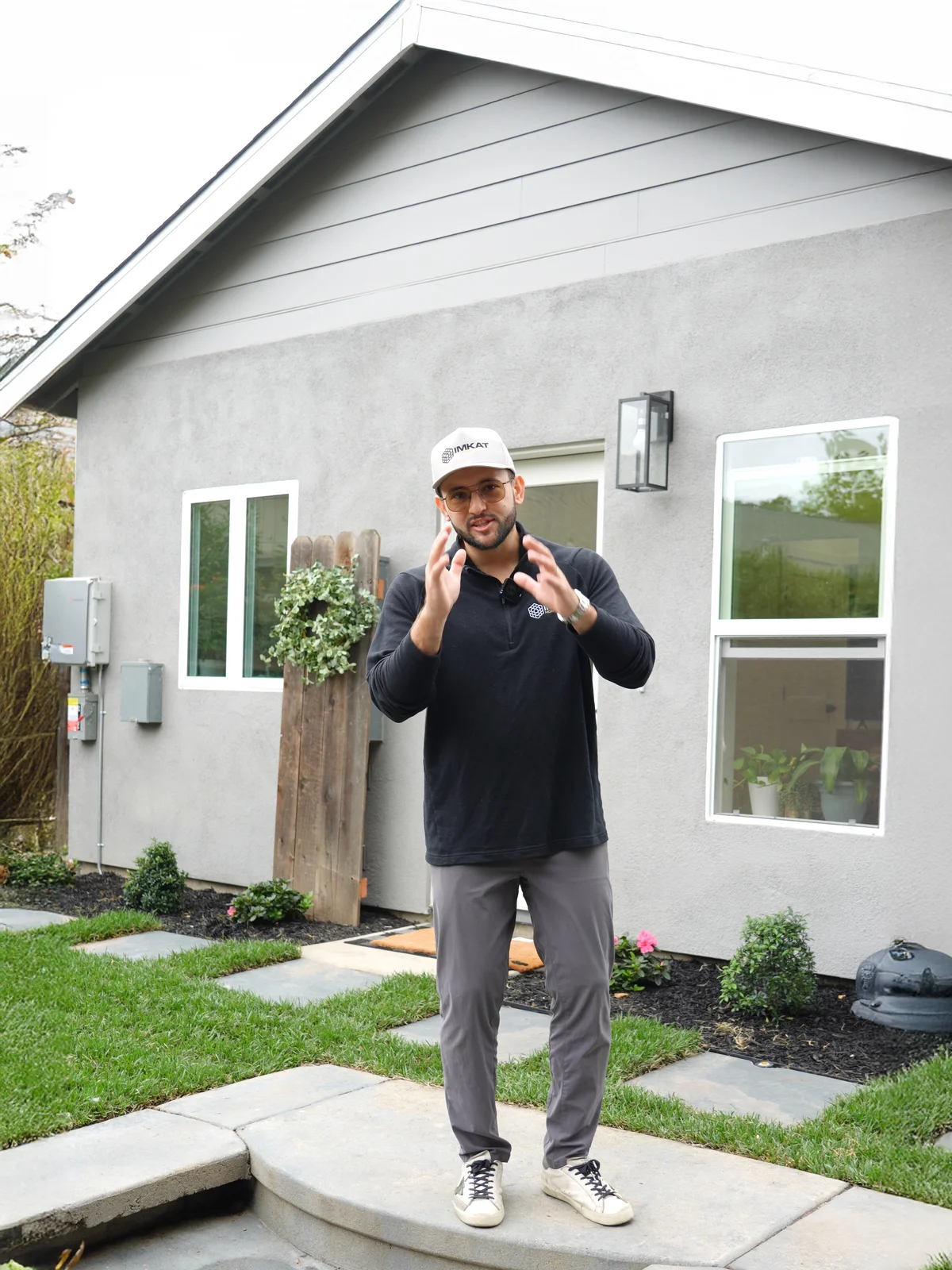 a man standing in front of a house