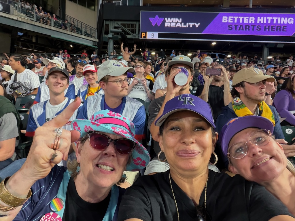 Group selfie at a Colorado Rockies game with Sober AF community members wearing branded jerseys.