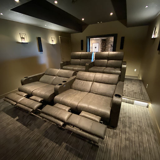Home theater with two rows of large leather seats in reclined position