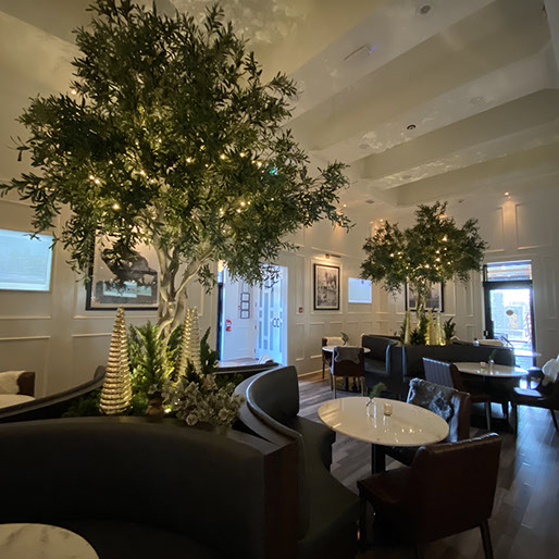Formal dining room with trees and tables