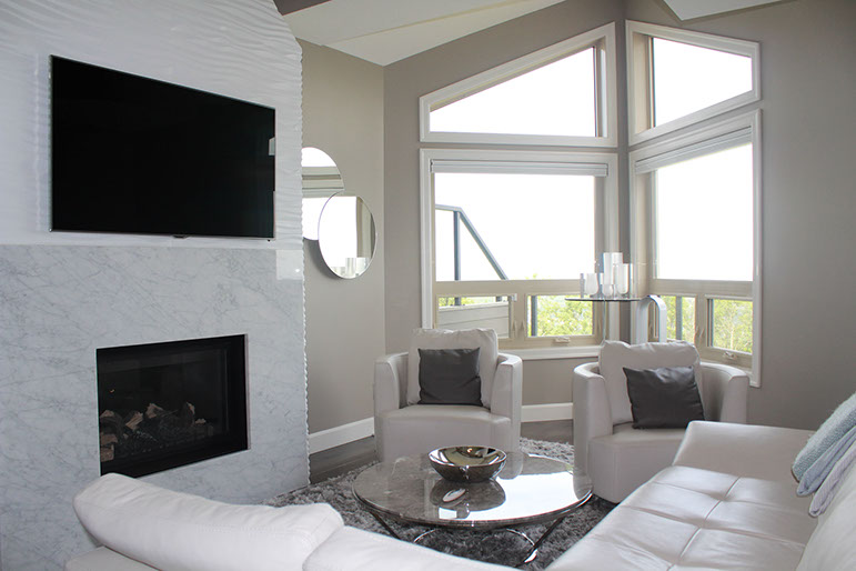 Fireplace with white custom wood paneling and TV