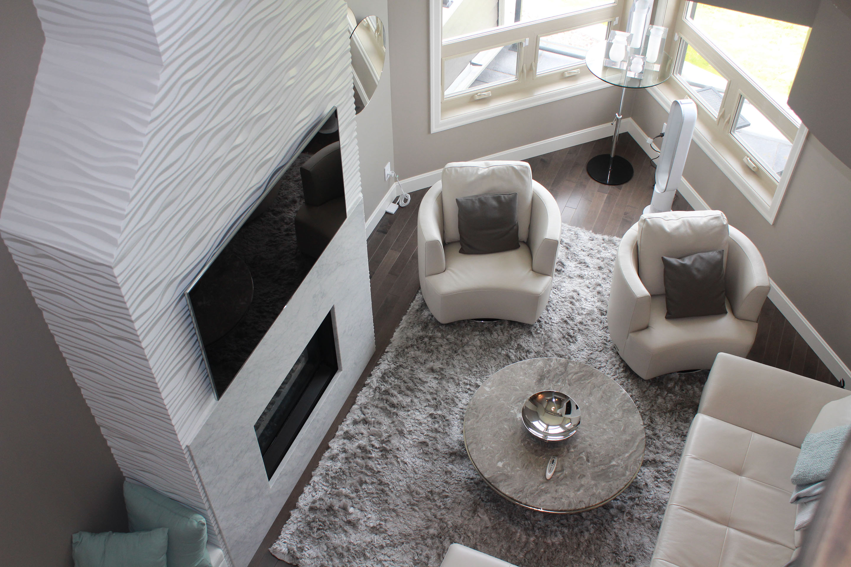 White fireplace with custom wood paneling and a TV installed on the front