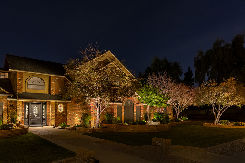 Brick house with landscape lighting
