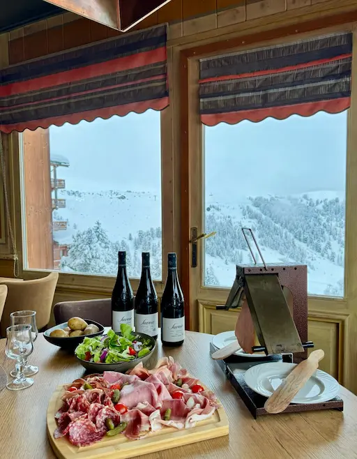Two small restaurant menus, with a rustic faux wood design and a red and white 'Le Chalet BAR - RESTAURANT' logo, are placed on a plain white surface.