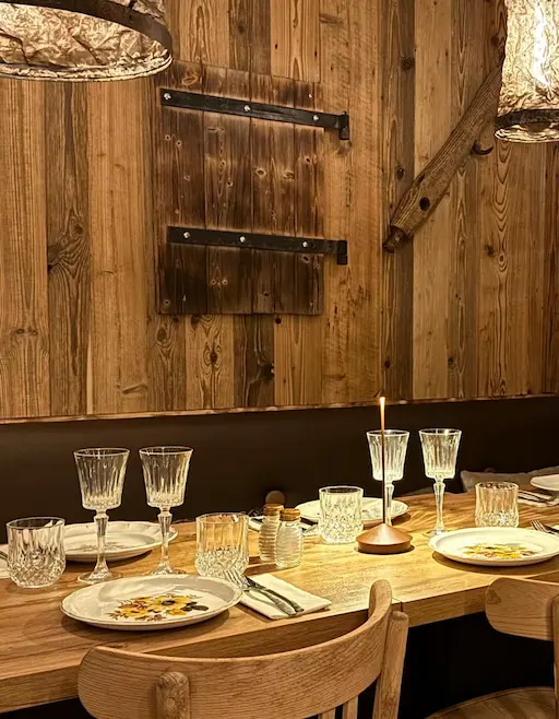 Table dressée au restaurant Chez Augustine, mettant en valeur la vaisselle et l’ambiance raffinée.