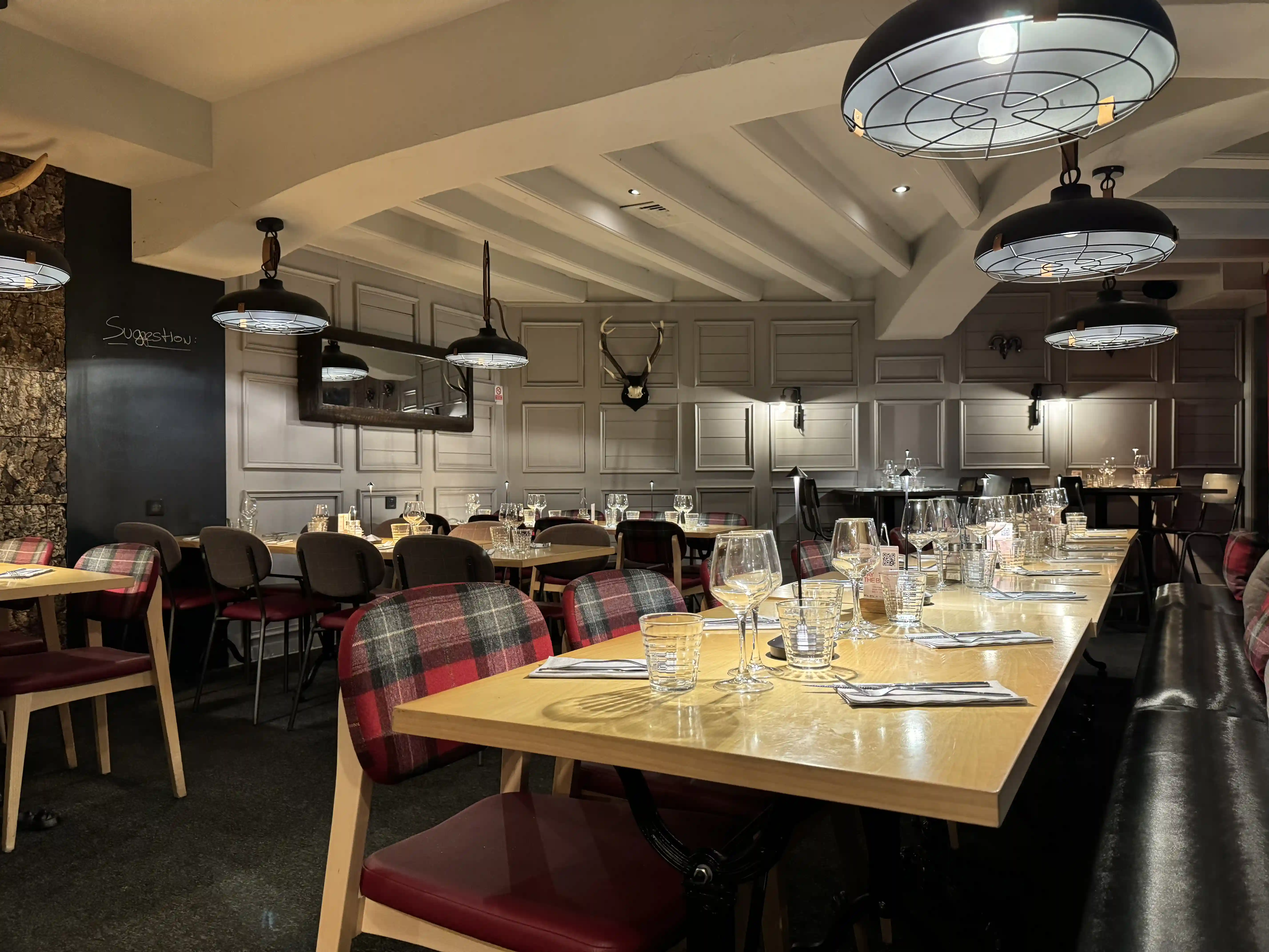 Restaurant Jasper and its large terrace set up with tables and chairs, completely covered in snow under the sun.