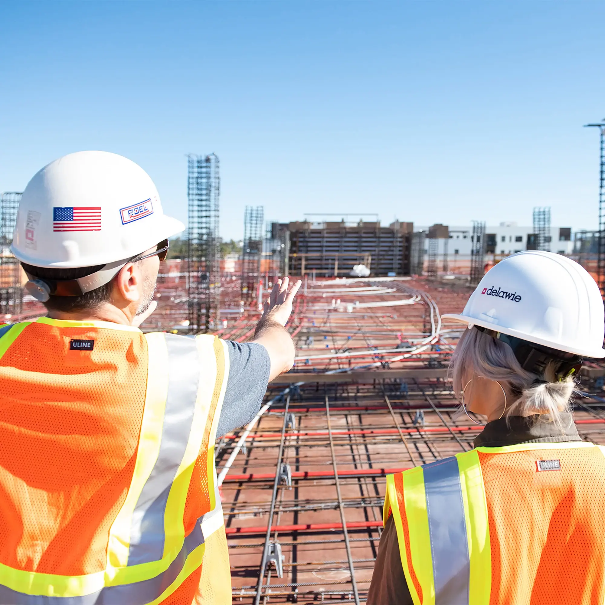 Profile of worker making a phone call on a construction job site