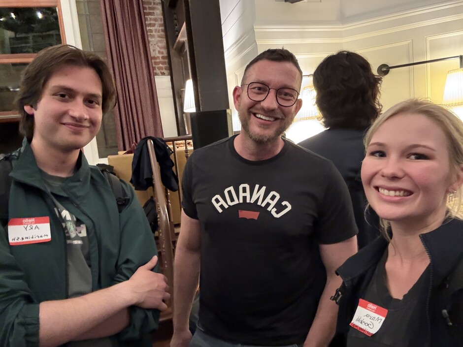Three attendees posing together in a photograph from Maritime’s launch announcement