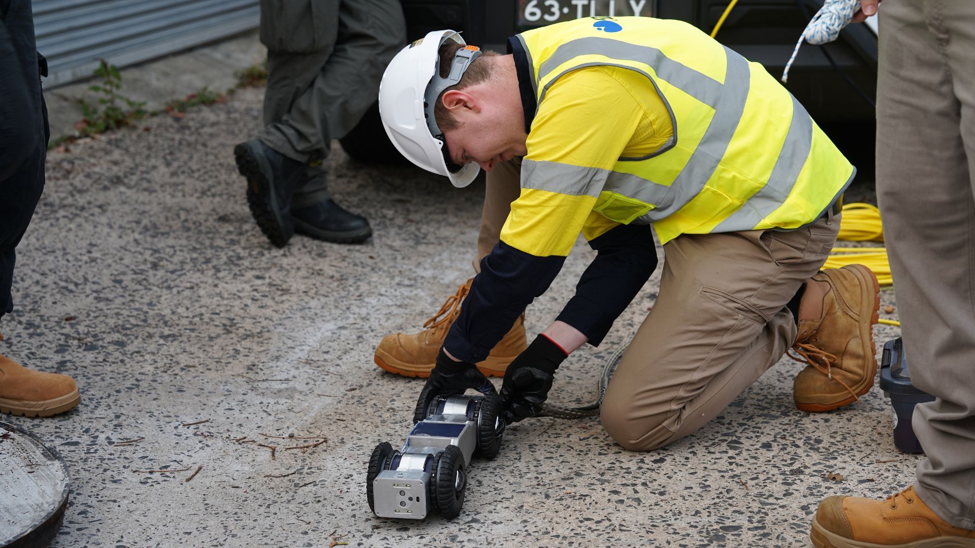 Puralink engineer placing the Ferret robot at a pipe access point during a field inspection