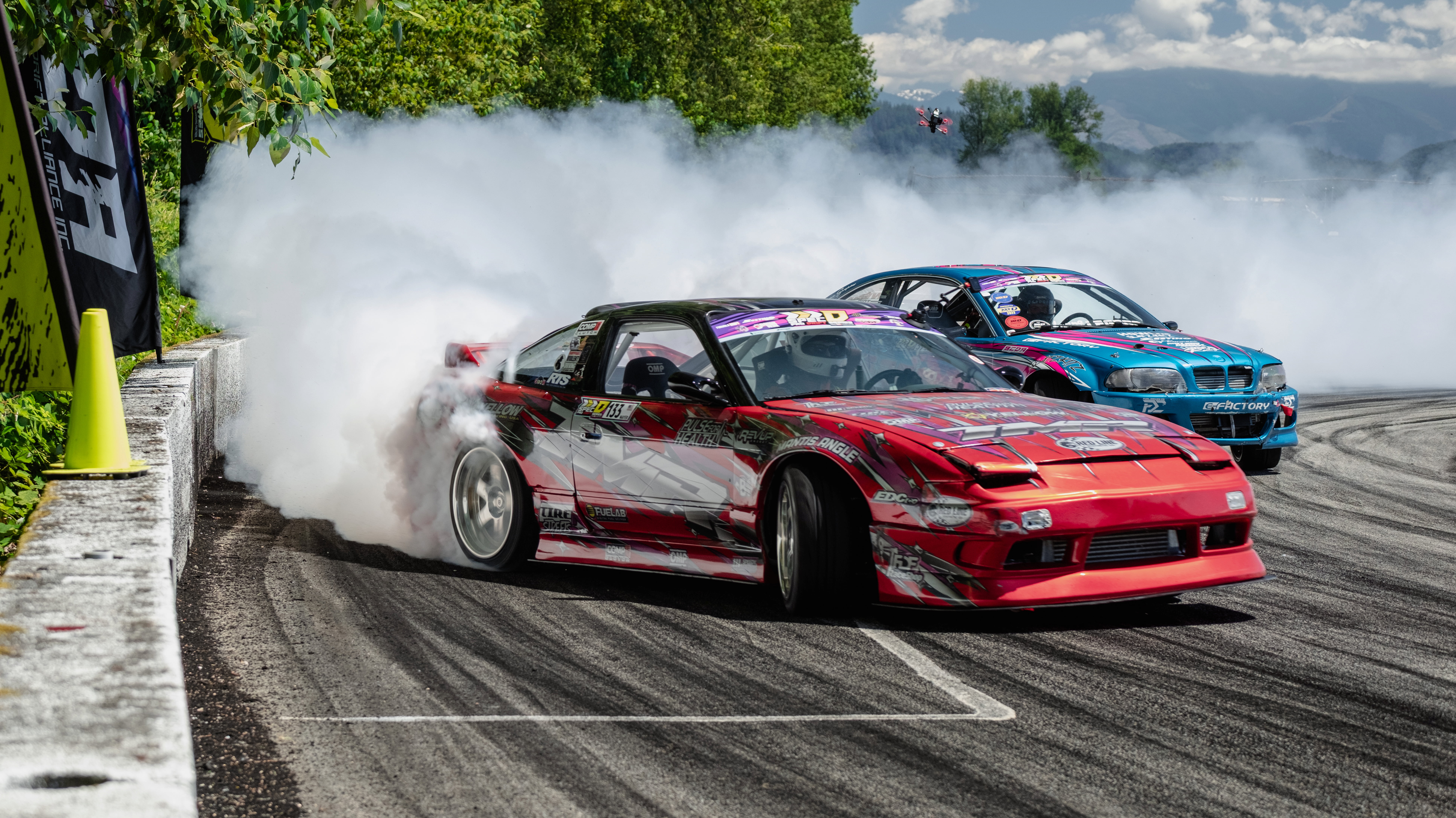 Dark green Chevrolet SS drag racing car on the track at night with spectators blurred in the background with Streetcar Addiction