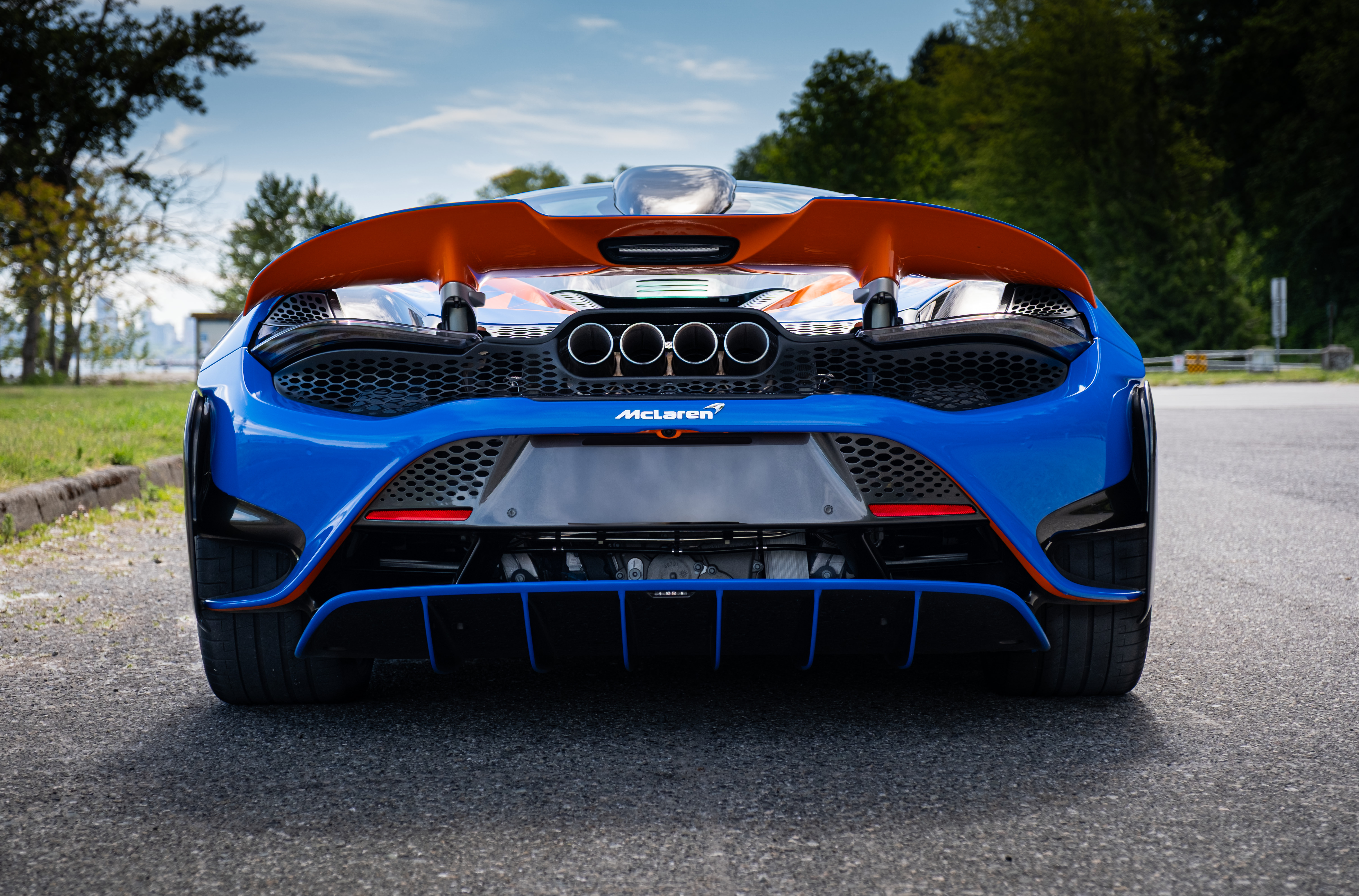 Black sports car with red racing stripes parked in a wet subway tunnel with headlights on with Streetcar Addiction