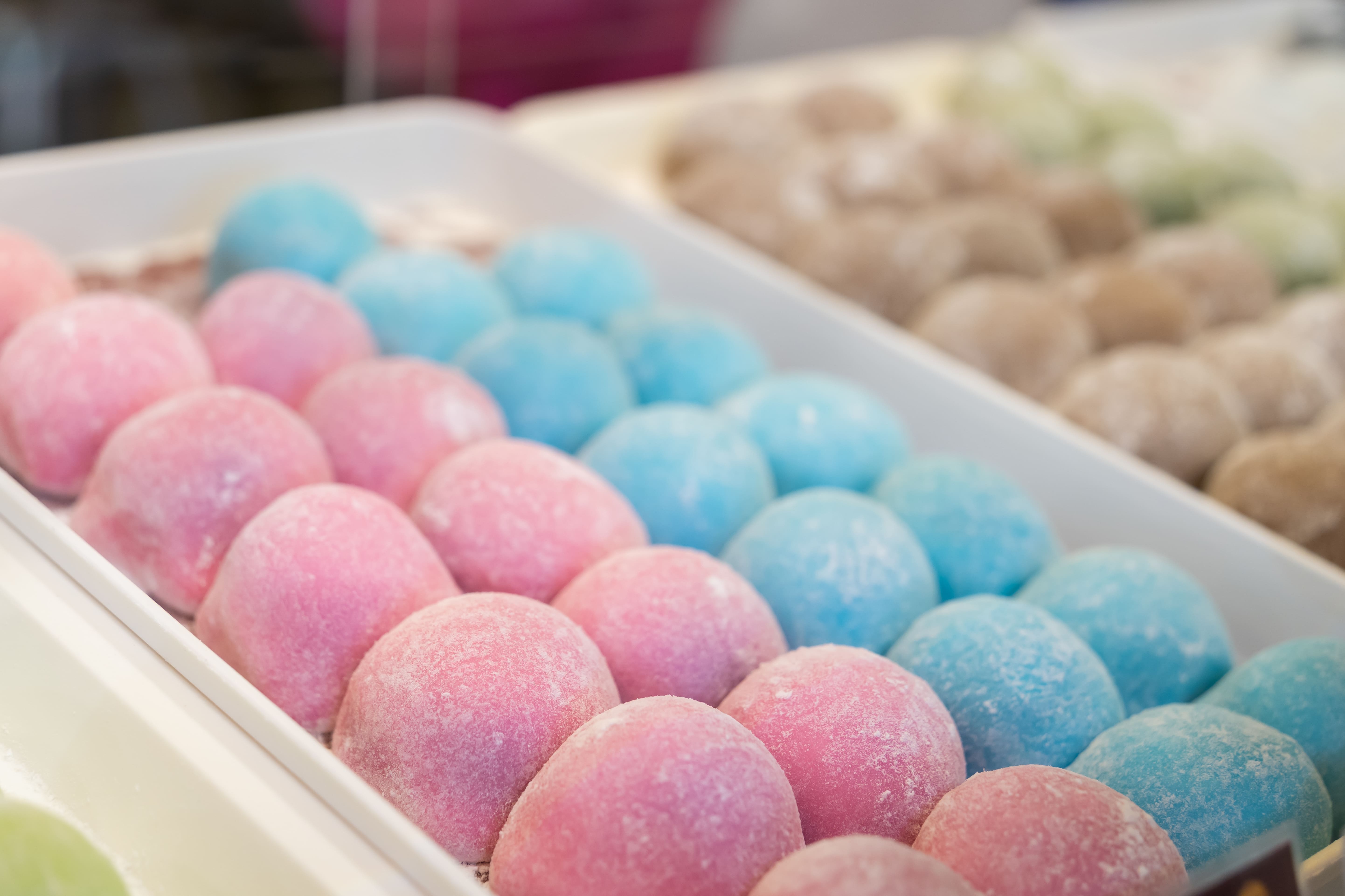 Trays of pastel-coloured mochi in pink, blue and beige