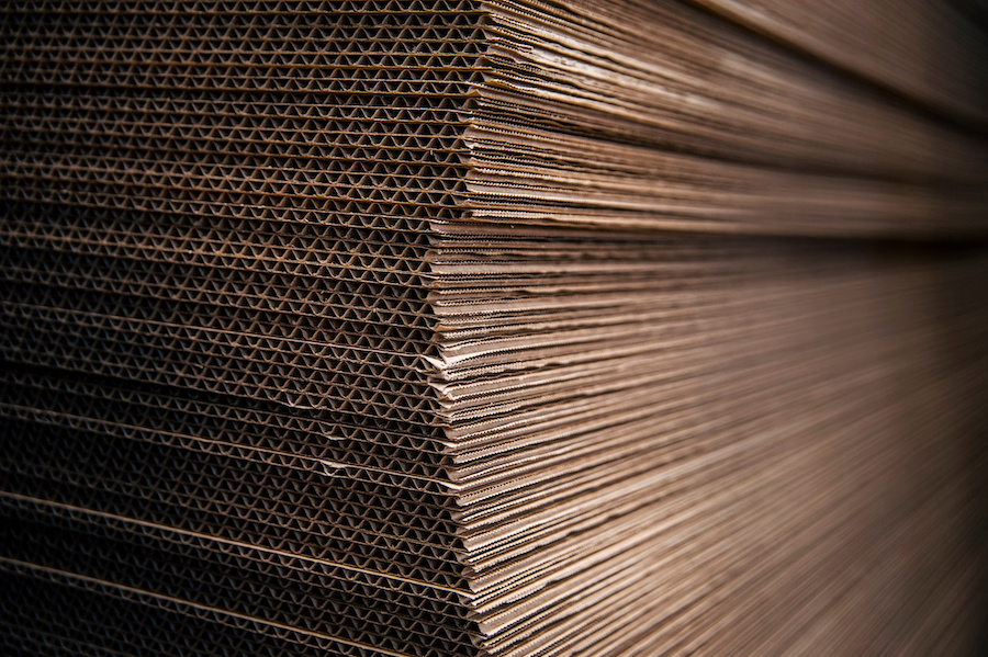 Stack of corrugated board sheets seen edge-on, showing the fluted layers