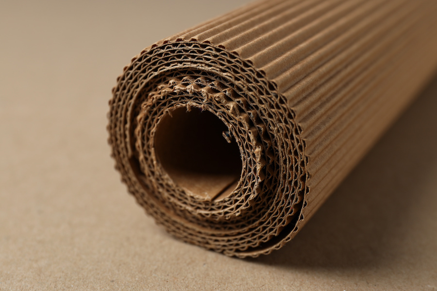 Roll of single-face corrugated cardboard on a brown surface