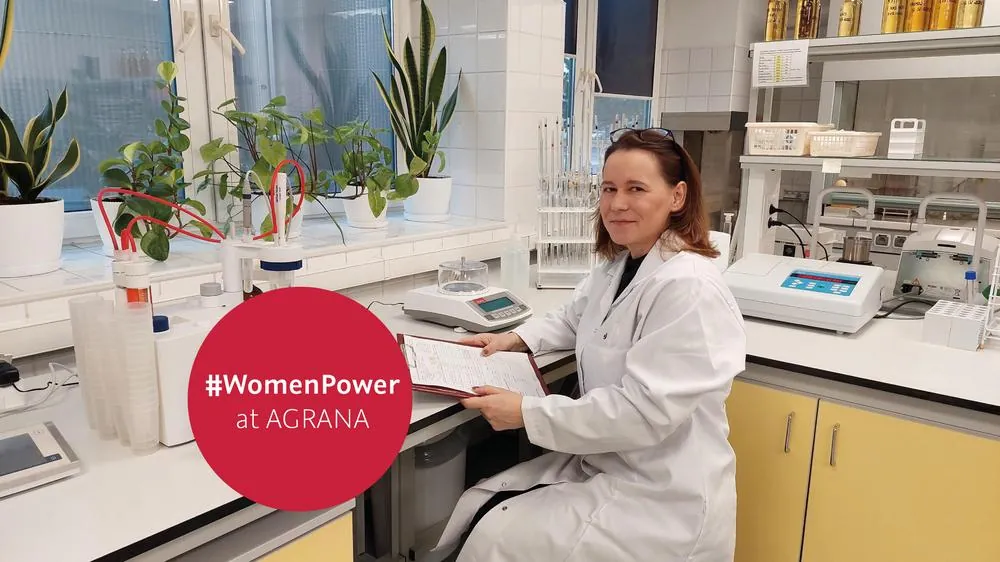 Aneta Miksza, head of quality at AGRANA Chelm, in a lab coat at a laboratory bench, badge #WomenPower at AGRANA