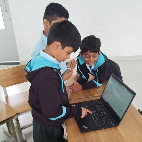 Young Quantium students exploring on a laptop together