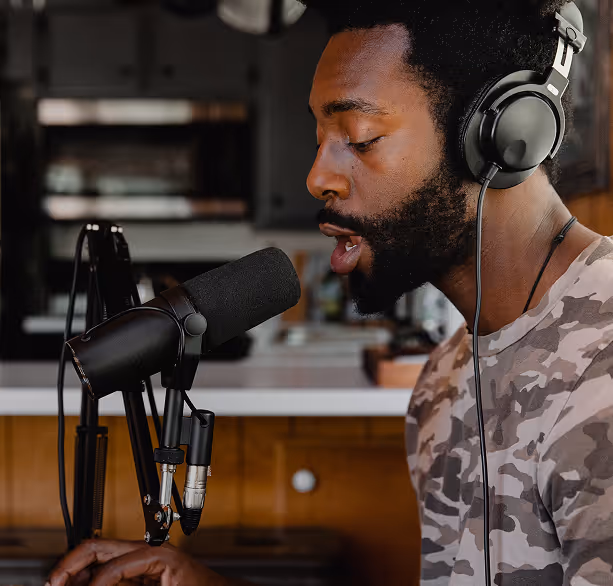 Man recording his album in a studio room.