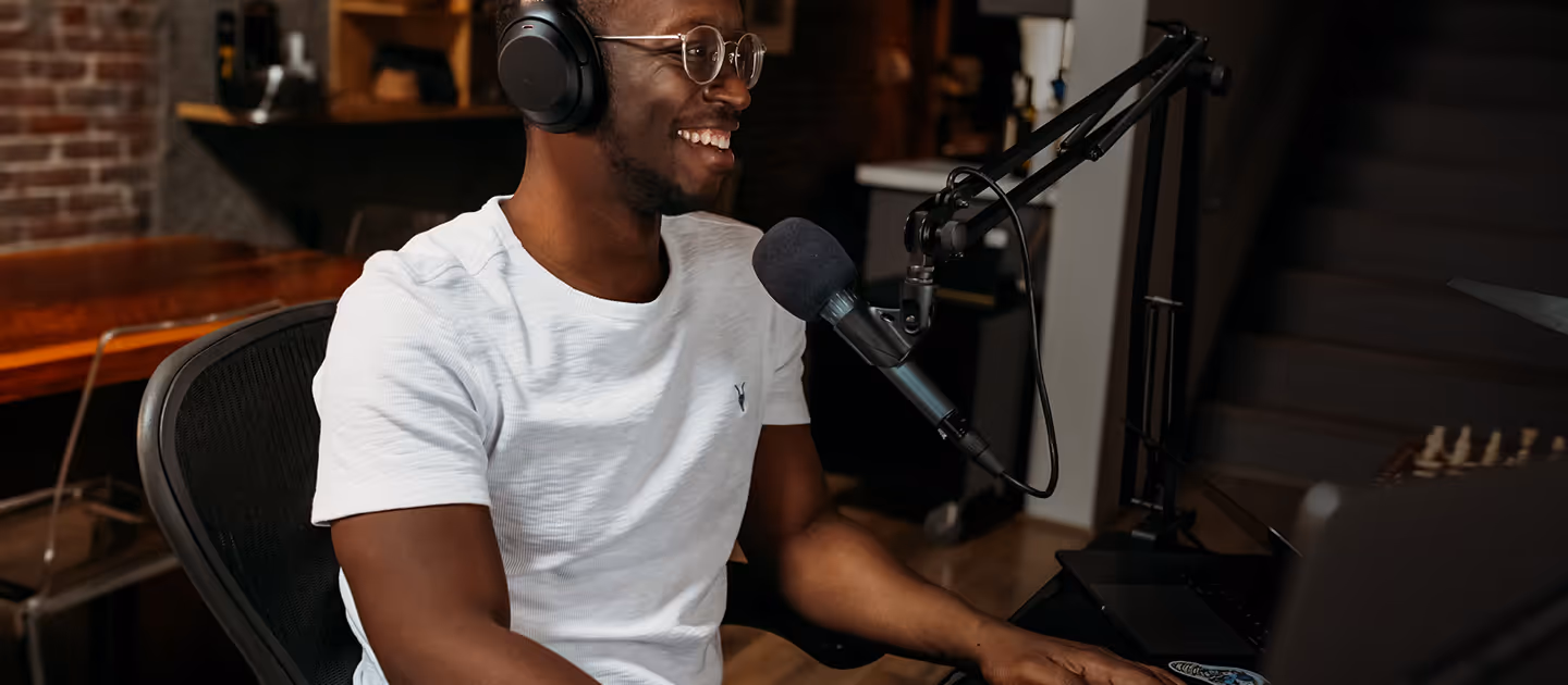 Man recording his album in a studio in a smile look.