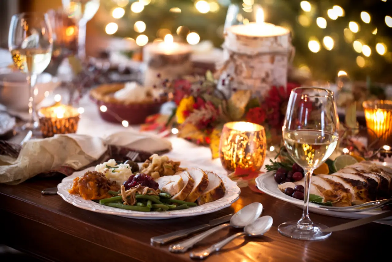 a candle lit setting with foods like gnocchi tossed in creamy mushroom sauce, oversized german hot dogs, classic swiss style fondue, and sugar dusted waffles