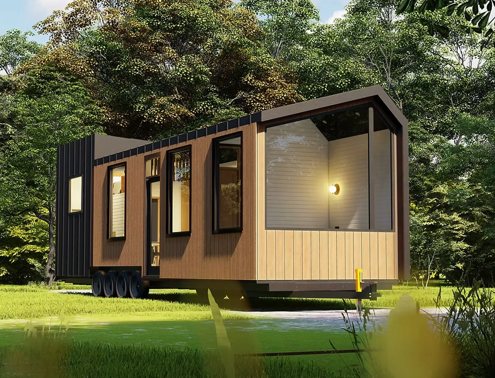 Modern tiny house on wheels with large windows surrounded by green trees and grass.