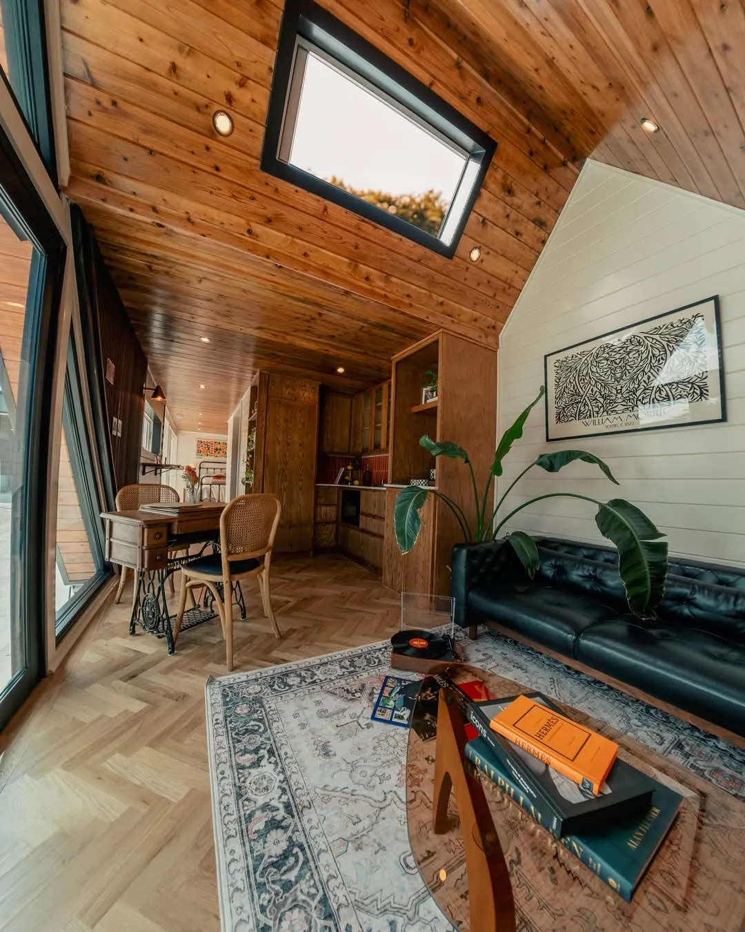 Living room with a skylight, leather sofa and patterned rug