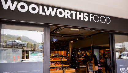 Entrance of Woolworths Food store with visible shopping area inside and signage above door.