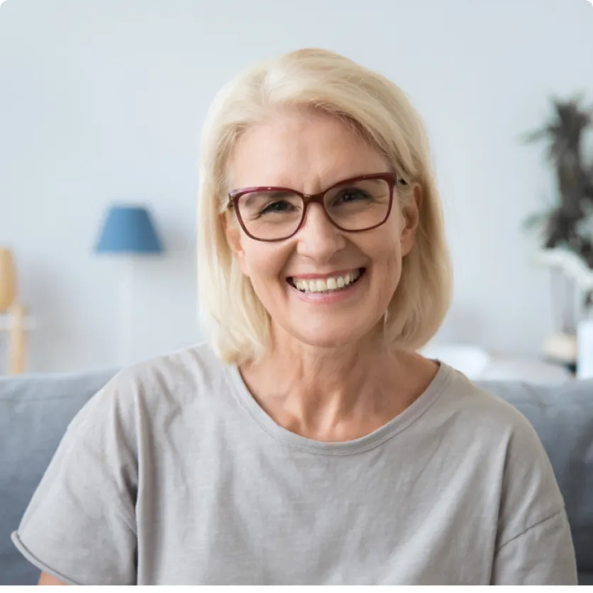 image of woman with glasses smiling for the camera
