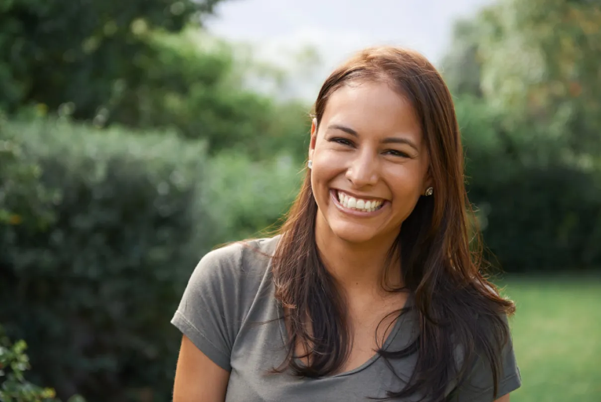 a woman with long hair smiling for the camera