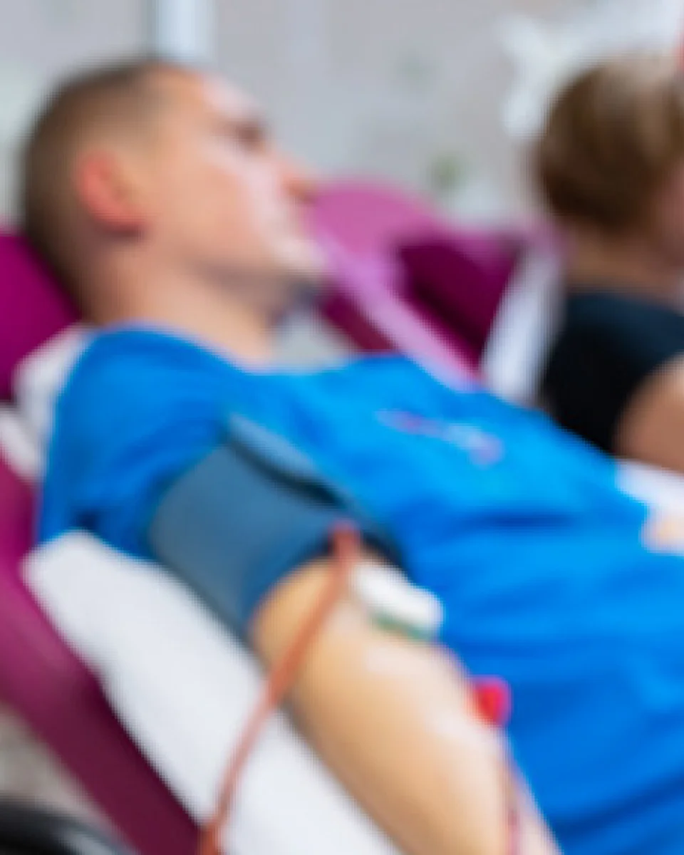 a man laying in a hospital bed with a cast on his arm